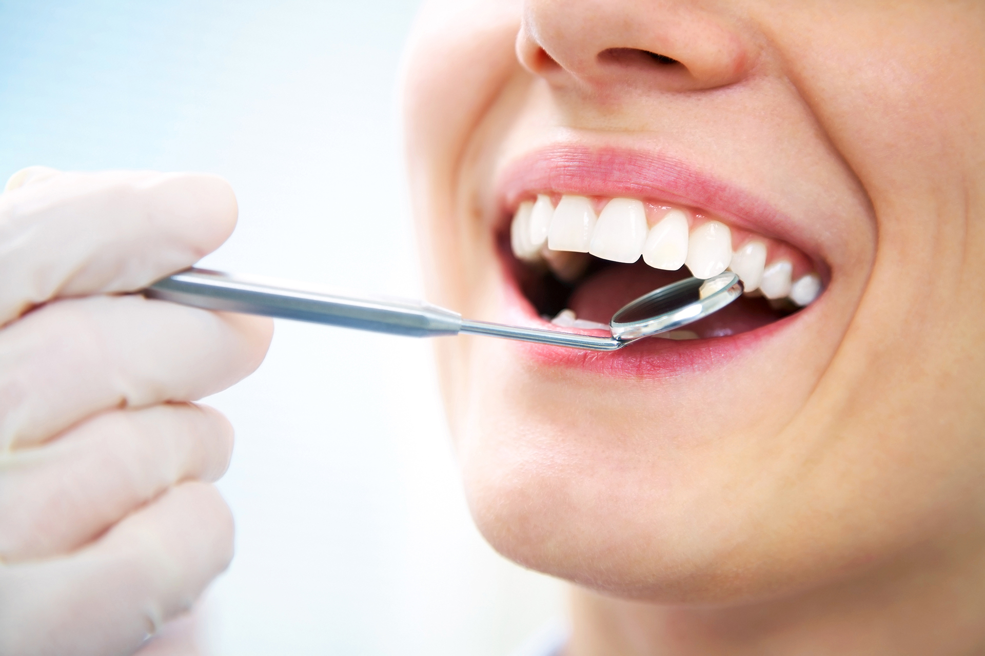 Close-up of young female having her teeth examinated